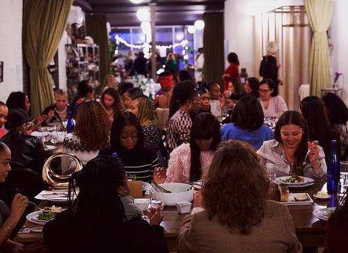 A woman speaks at a Women Over Dinner gathering